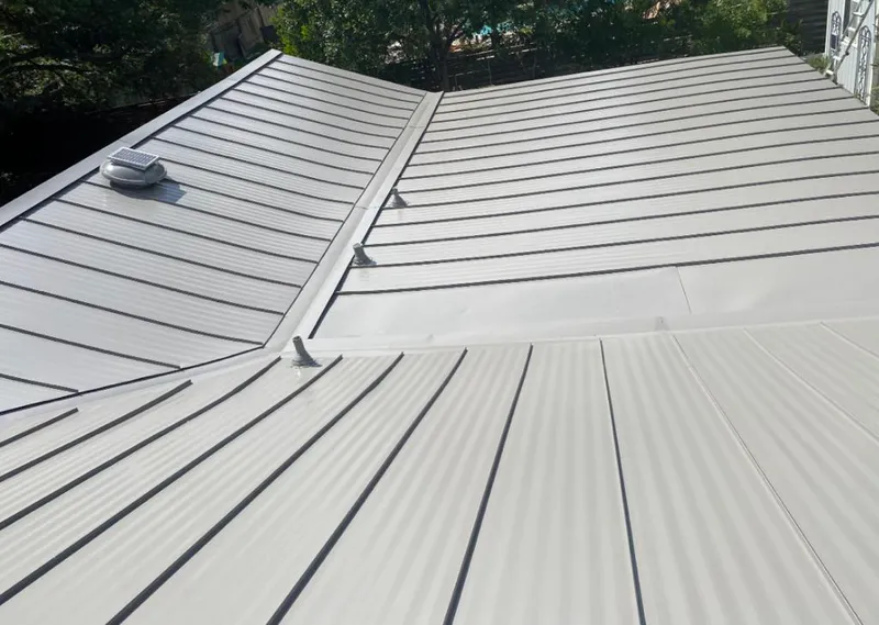 Solar attic fan installed on a metal roof for Roof Ventilation in Richland